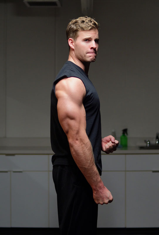 A photo of the coach showing his developed tricep muscles.